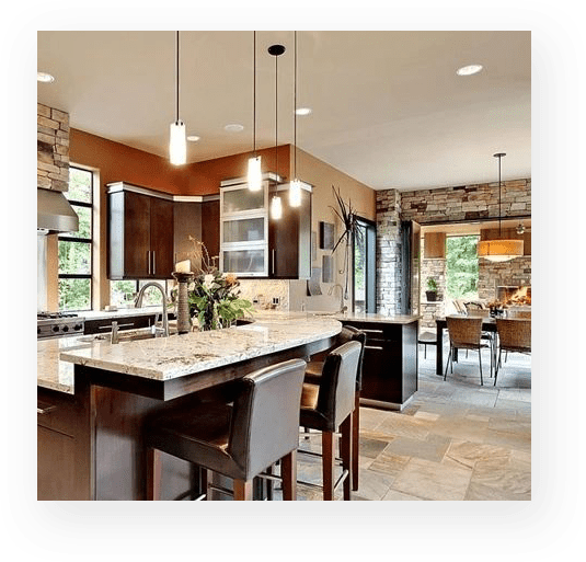A kitchen with a large island and granite counter tops.
